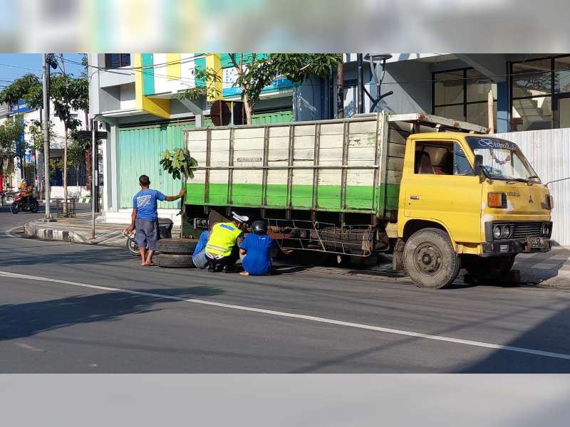 Viral, Polisi Bojonegoro Bantu Mengelas Baut Roda Truk yang Lepas